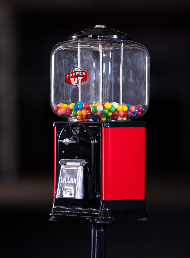 Refinished vintage Topper gumball machine with red and black powder-coated exterior by Biltwood Powder Coating.